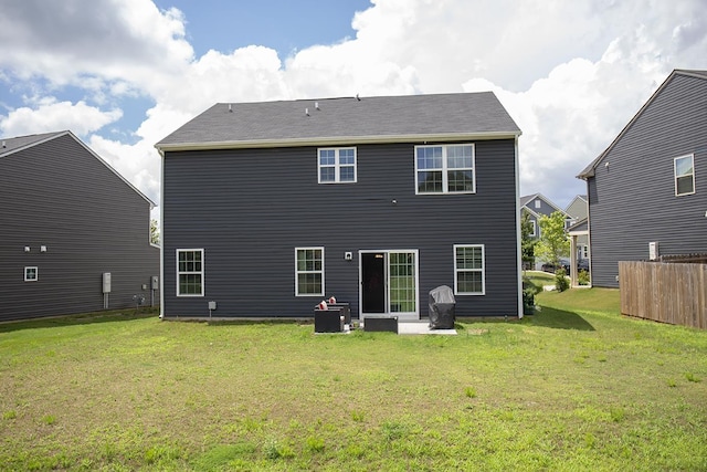 rear view of house with a yard