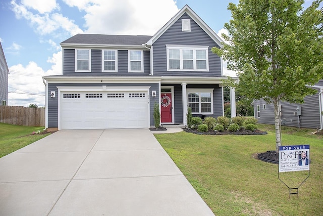 view of front of property with a front lawn and a garage