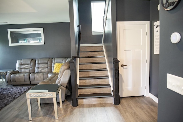 stairs featuring hardwood / wood-style flooring