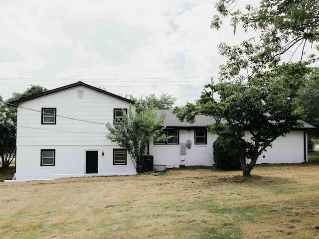 back of property featuring a lawn