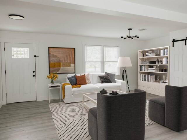 living room with hardwood / wood-style flooring and a barn door