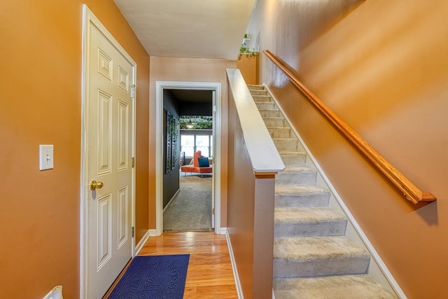 stairway with light wood-type flooring