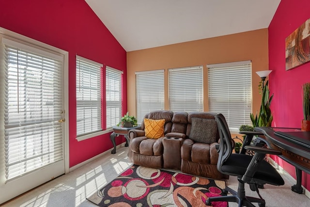 office with carpet floors and vaulted ceiling