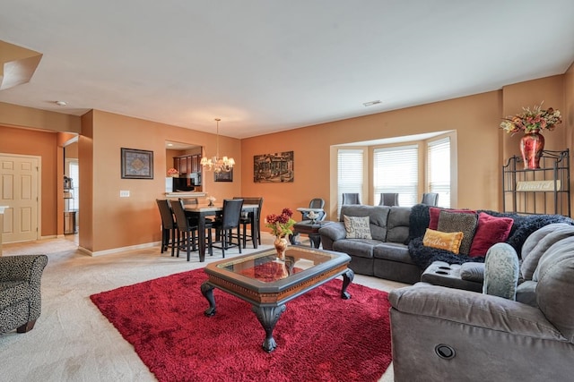 carpeted living room with a chandelier