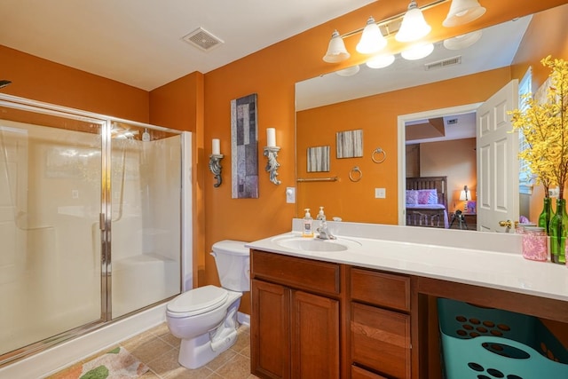 bathroom featuring a shower with door, vanity, tile patterned flooring, and toilet