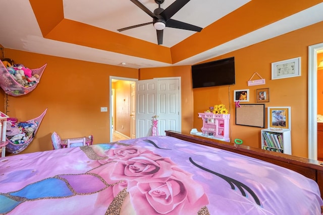 bedroom featuring ceiling fan and a tray ceiling