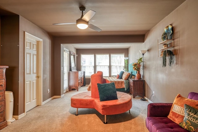 living room featuring light colored carpet and ceiling fan