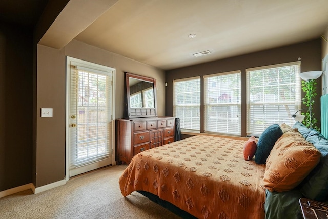 carpeted bedroom with access to exterior