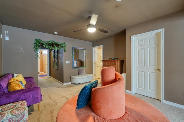 carpeted living room with ceiling fan