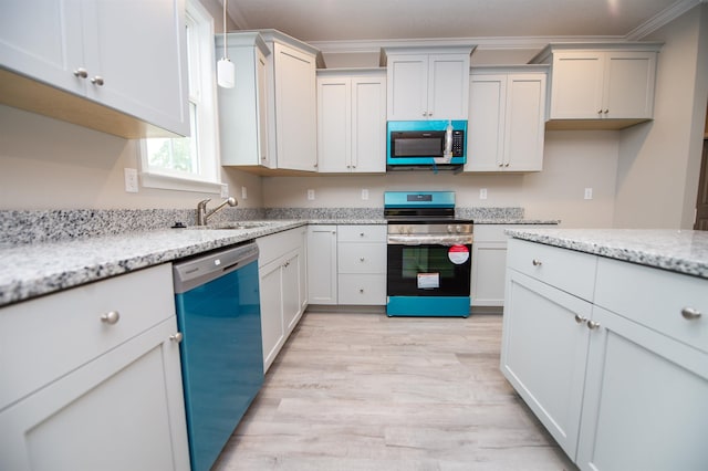 kitchen with stainless steel appliances, crown molding, light wood-style flooring, a sink, and light stone countertops