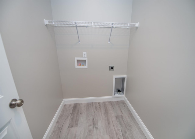 washroom with light wood-style floors, hookup for a washing machine, electric dryer hookup, and baseboards