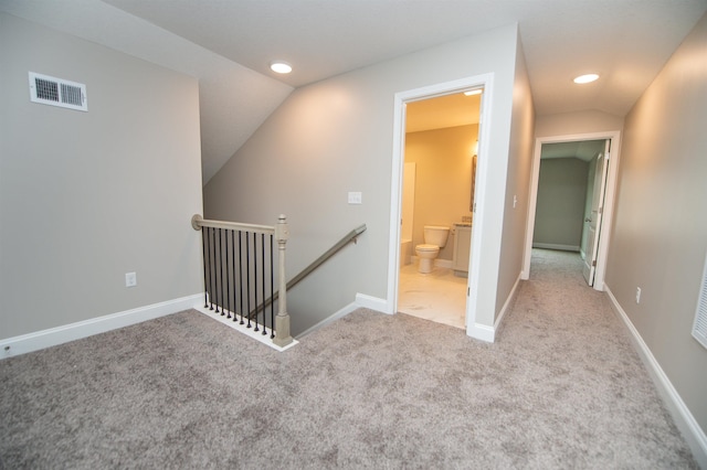 corridor featuring an upstairs landing, lofted ceiling, carpet floors, recessed lighting, and baseboards