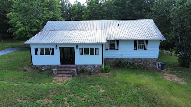 view of front of home with central AC unit and a front lawn