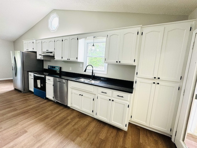 kitchen featuring sink, vaulted ceiling, appliances with stainless steel finishes, dark hardwood / wood-style flooring, and white cabinetry