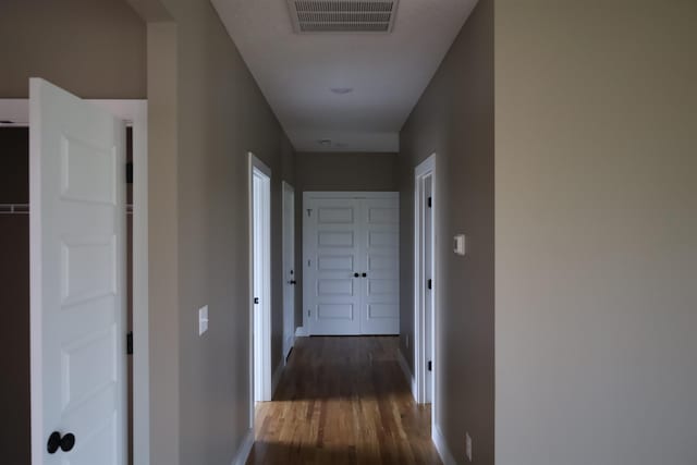 corridor with dark wood-type flooring