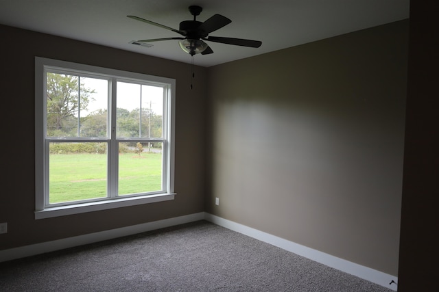 empty room featuring ceiling fan, a healthy amount of sunlight, and carpet flooring