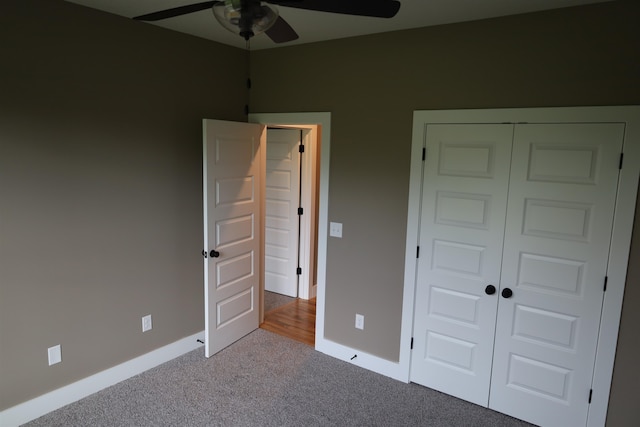 unfurnished bedroom with ceiling fan, light colored carpet, and a closet