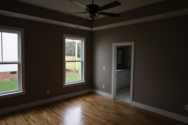 empty room with hardwood / wood-style flooring and ceiling fan