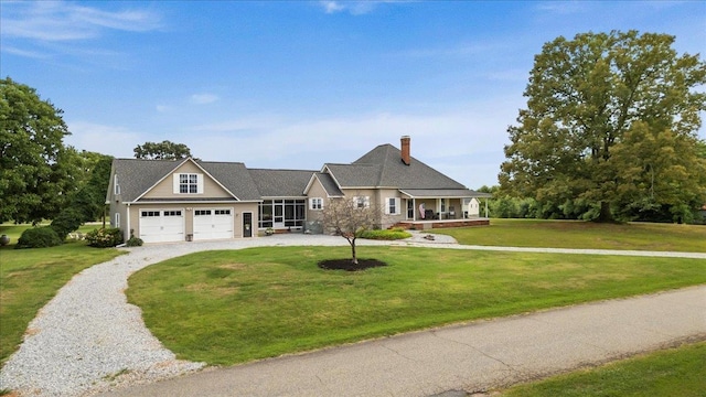 view of front of property with a porch, a garage, and a front yard