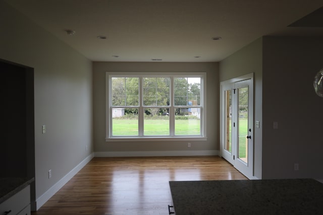 unfurnished dining area with light hardwood / wood-style floors