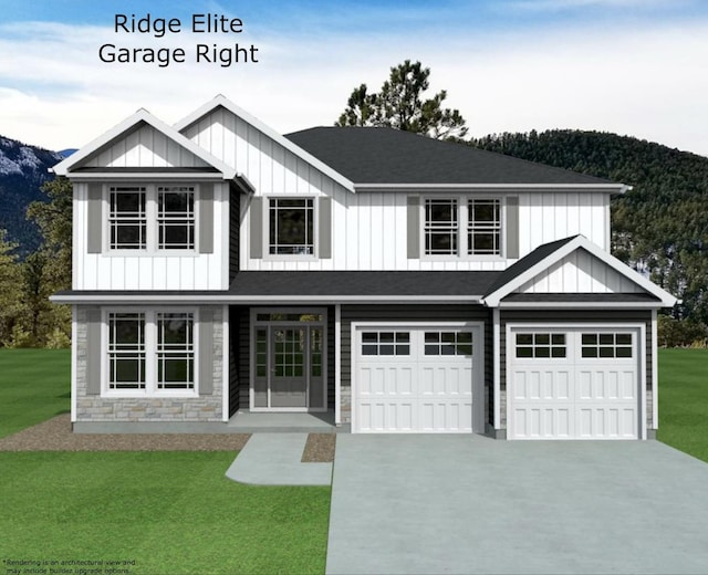 view of front of property with a garage, a mountain view, and a front lawn