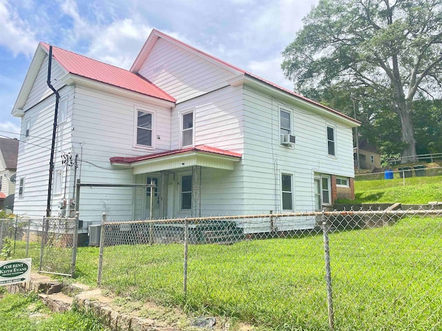 view of front of house with central air condition unit, cooling unit, and a front lawn