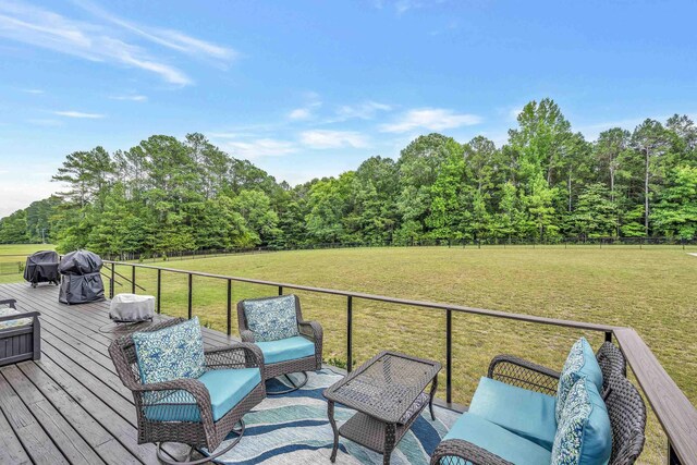 wooden terrace featuring a lawn