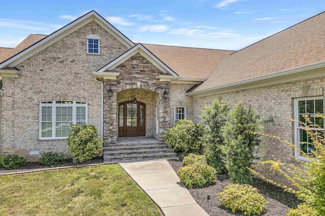 view of front of property with a front yard and french doors