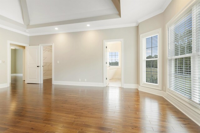 unfurnished room featuring dark hardwood / wood-style flooring, ornamental molding, and a raised ceiling