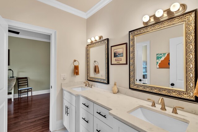 bathroom featuring crown molding, vanity, and hardwood / wood-style flooring