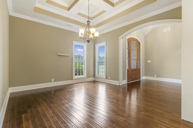 spare room with coffered ceiling, an inviting chandelier, ornamental molding, dark hardwood / wood-style flooring, and beamed ceiling