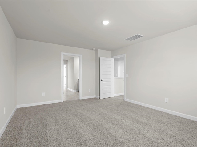 empty room featuring light colored carpet