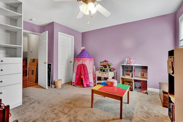 playroom with ceiling fan and light colored carpet