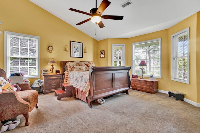 carpeted bedroom with multiple windows, ceiling fan, and lofted ceiling