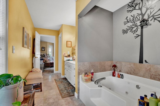 bathroom with vanity, tile patterned floors, and a tub to relax in