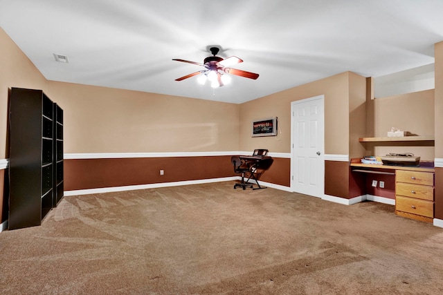 carpeted home office with ceiling fan