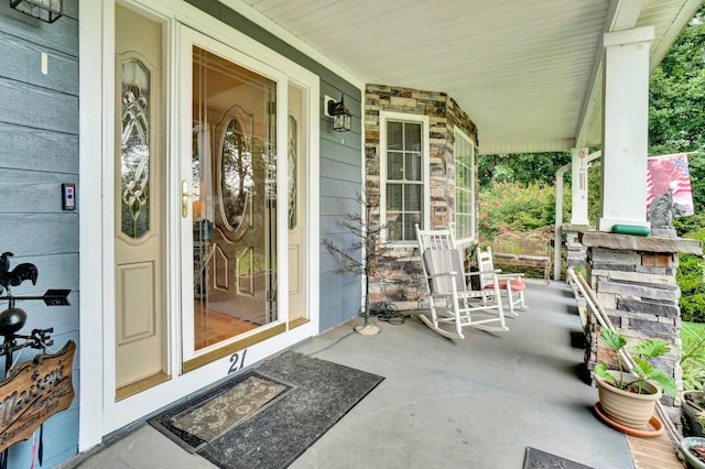 view of exterior entry with covered porch