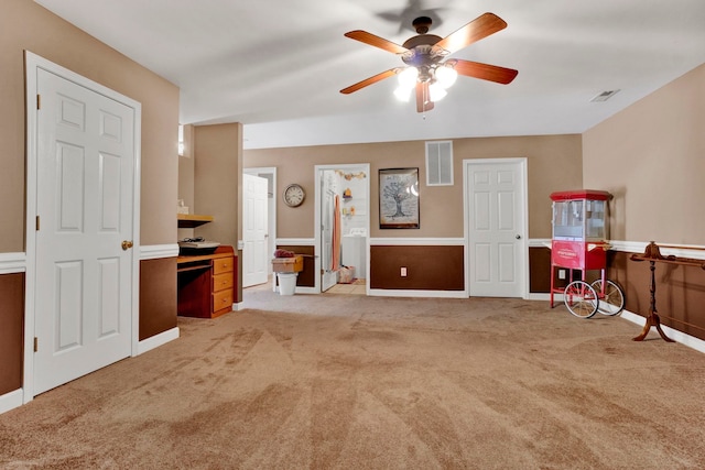 interior space featuring light carpet and ceiling fan