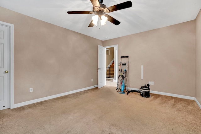 misc room with light carpet and ceiling fan