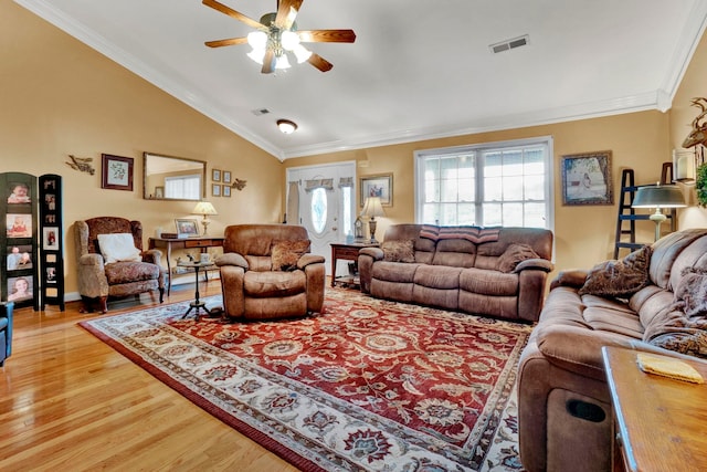 living room featuring crown molding, lofted ceiling, light hardwood / wood-style flooring, and ceiling fan