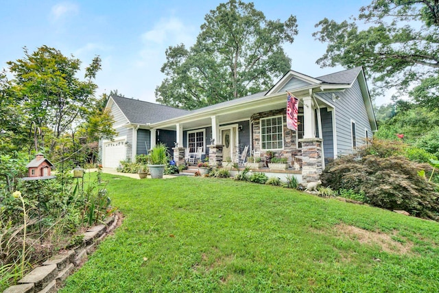 view of front of house featuring a porch, a garage, and a front yard