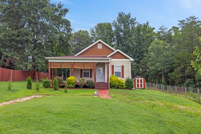 view of front of home with a shed and a front yard