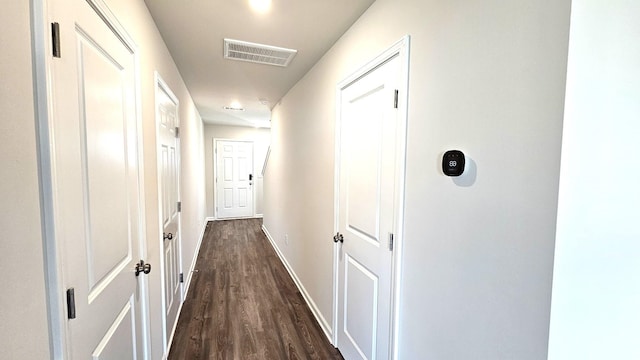 hallway with dark hardwood / wood-style flooring