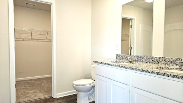 bathroom with vanity, hardwood / wood-style floors, and toilet