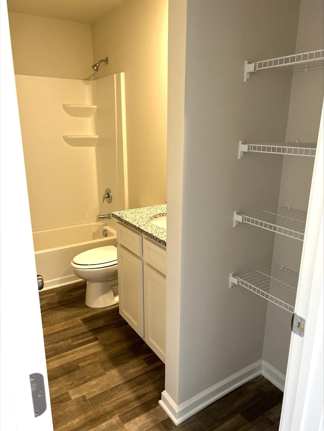 full bathroom featuring vanity, toilet, shower / bath combination, and hardwood / wood-style floors