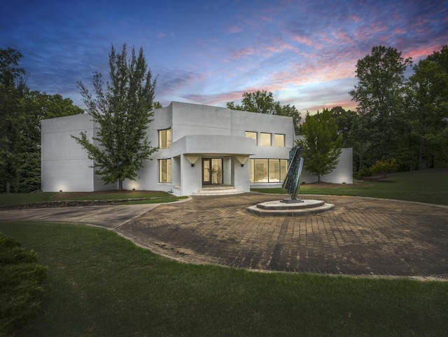 contemporary home with a lawn