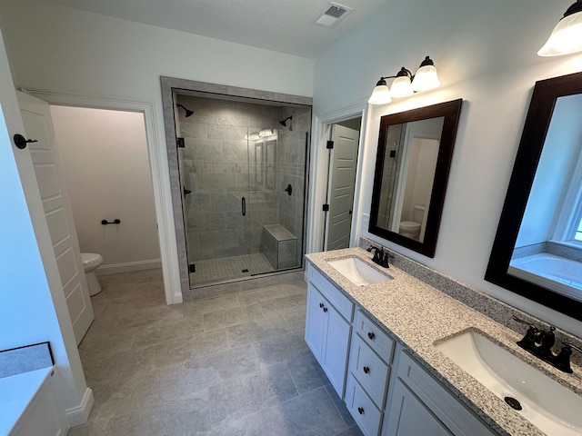 full bathroom featuring toilet, independent shower and bath, and vanity