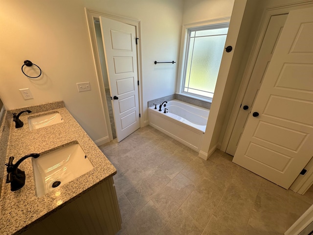 bathroom featuring vanity and a tub