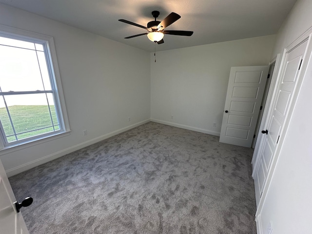 unfurnished bedroom with ceiling fan and light colored carpet