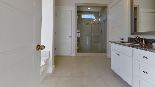 bathroom with vanity, a shower with shower door, and tile patterned floors